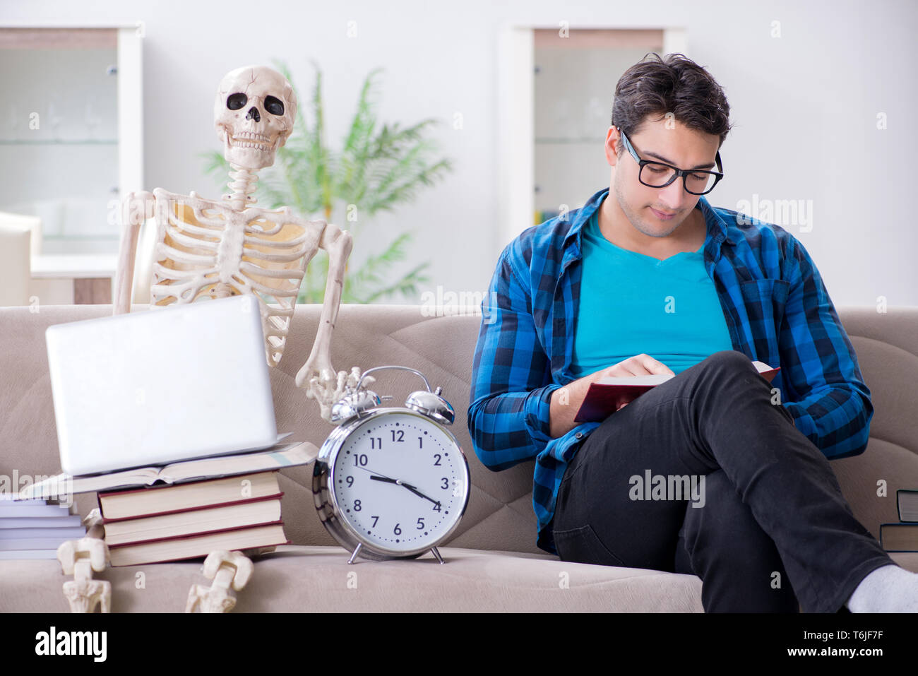 Student studying with skeleton preparing for exams Stock Photo