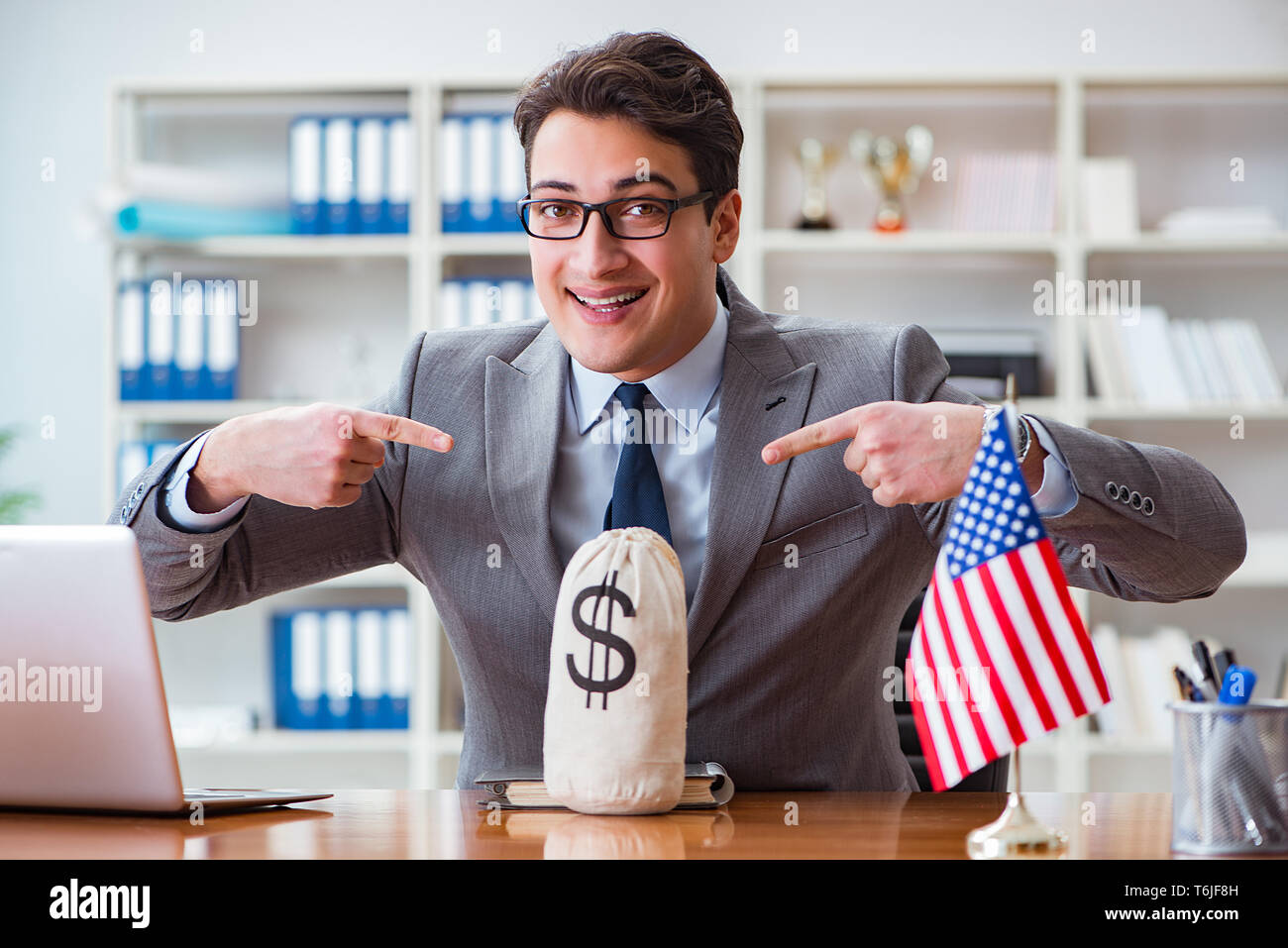 Businessman with American flag in office Stock Photo