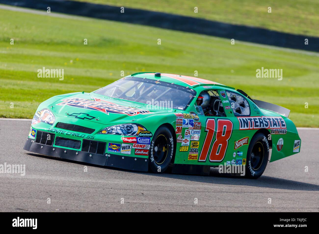 2007 Chevrolet Monte Carlo SS NASCAR with driver Warren Briggs during a demonstration run at the 77th Goodwood GRRC Members Meeting, Sussex, UK Stock Photo