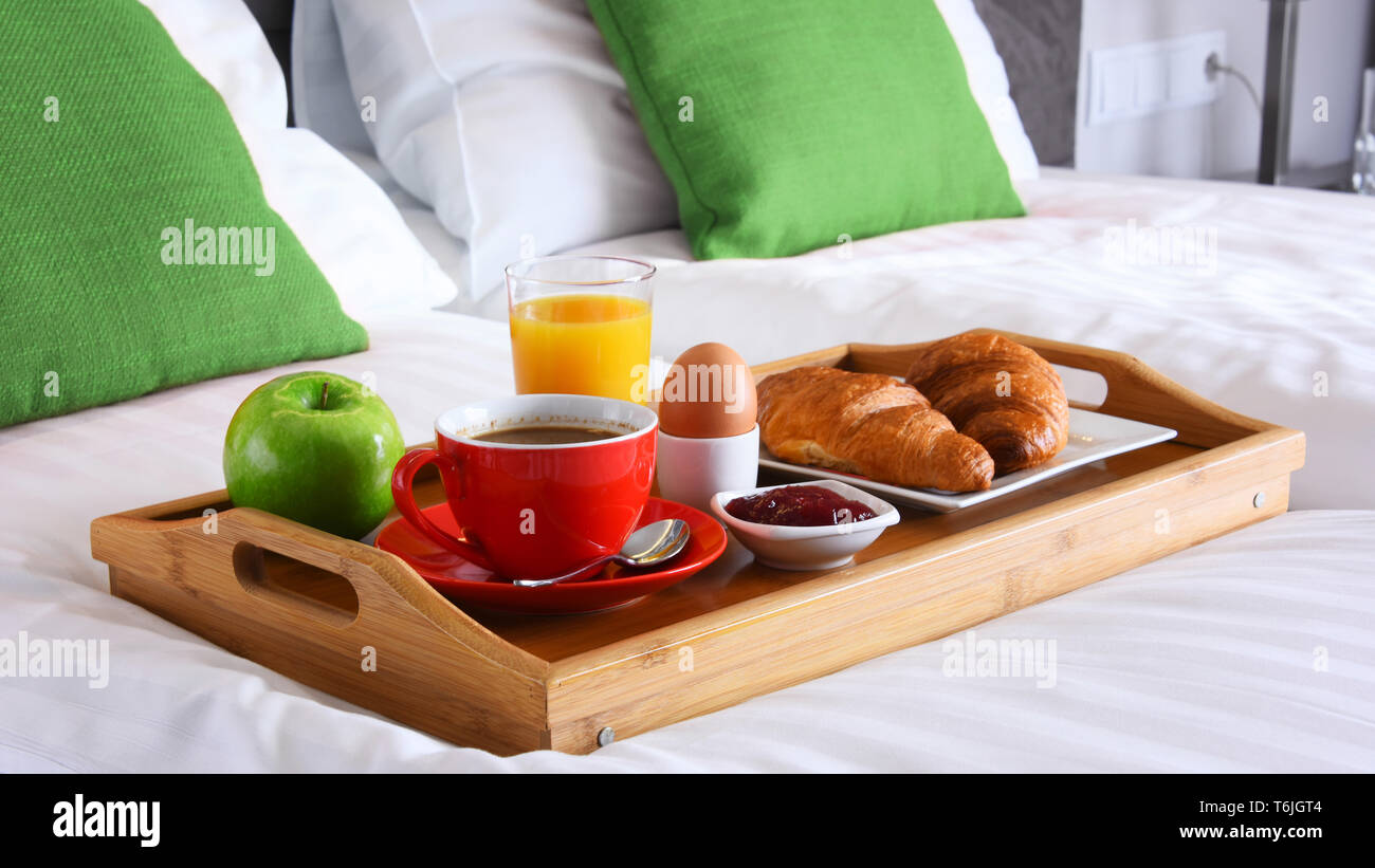 Breakfast on tray in bed in hotel room Stock Photo - Alamy