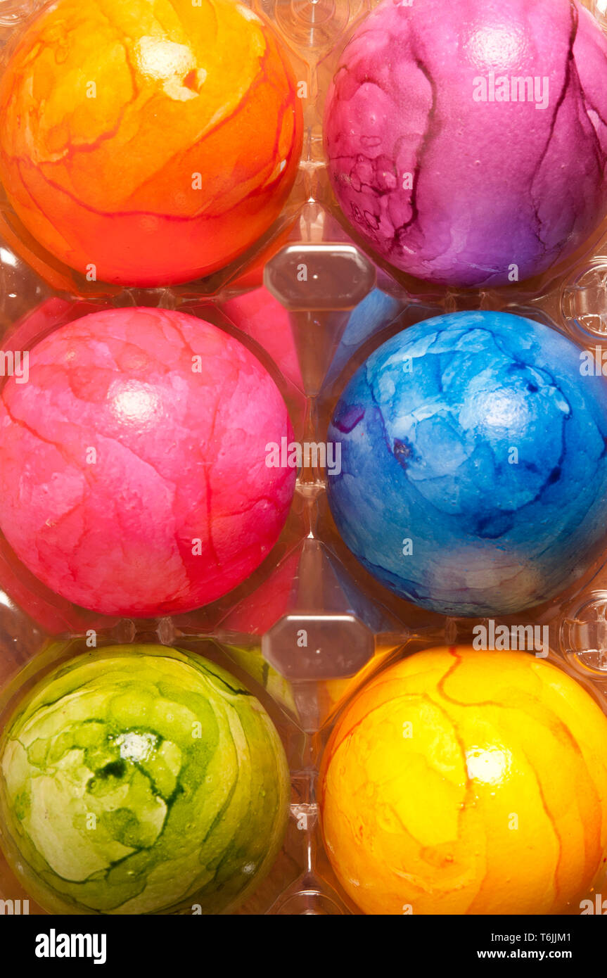 colourful painted Easter eggs in plastic container Stock Photo