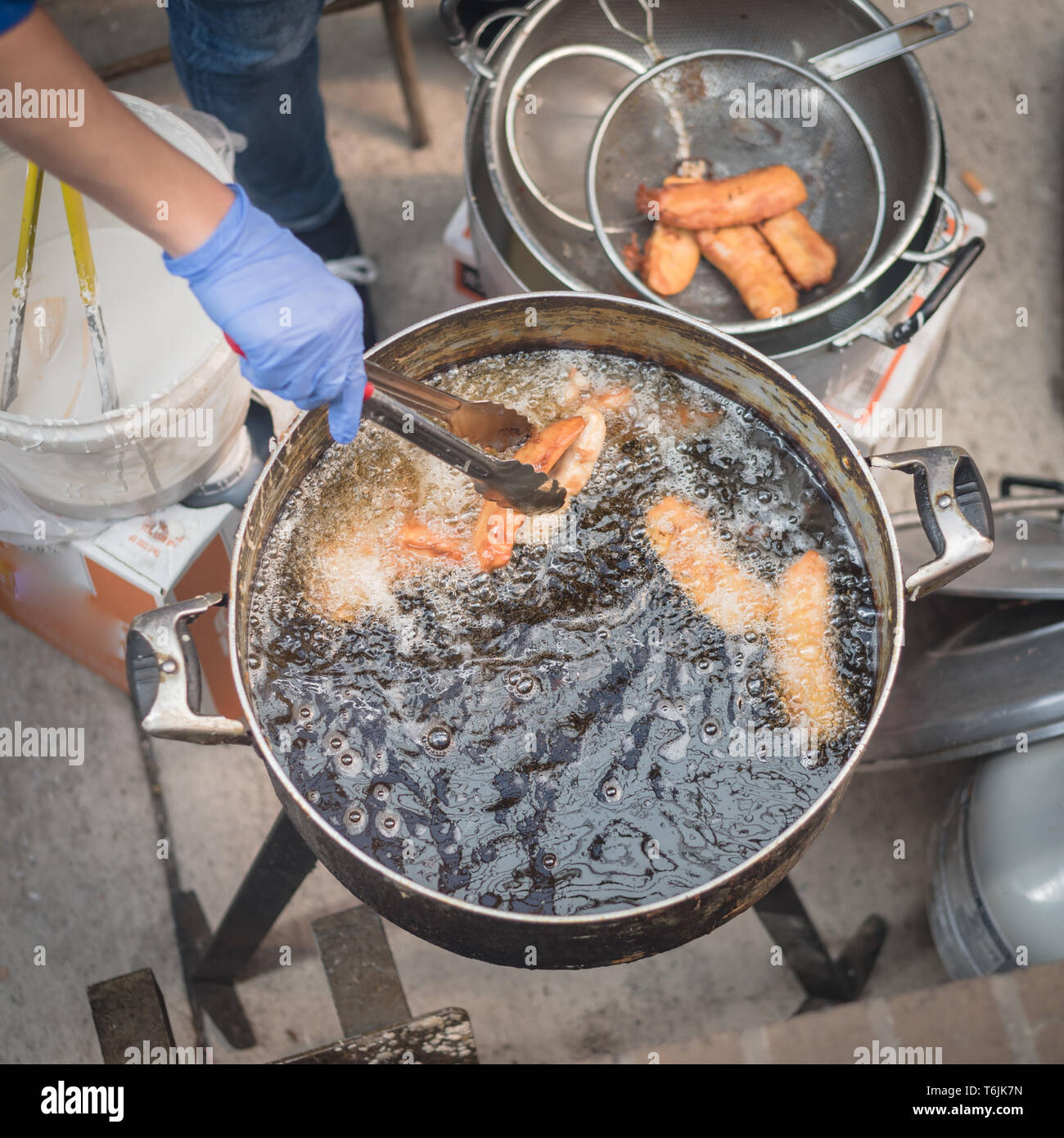 Closeup top view deep fried rice flour cakes in hot and flaming oil
