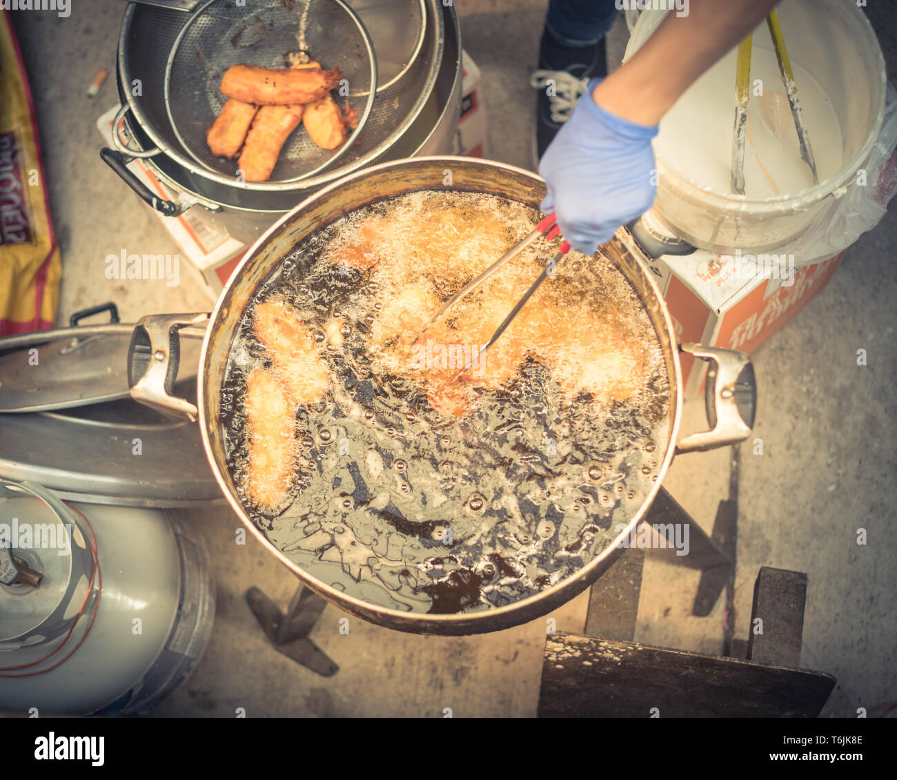 Closeup top view deep fried rice flour cakes in hot and flaming oil