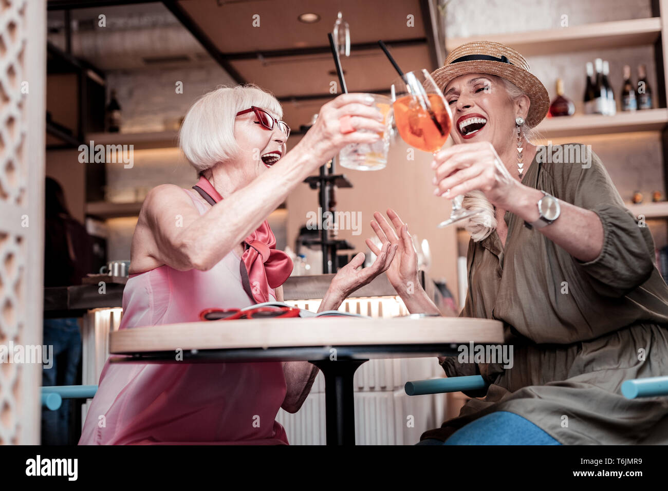 Joyful well maintained old ladies spending great time in a cafe Stock Photo