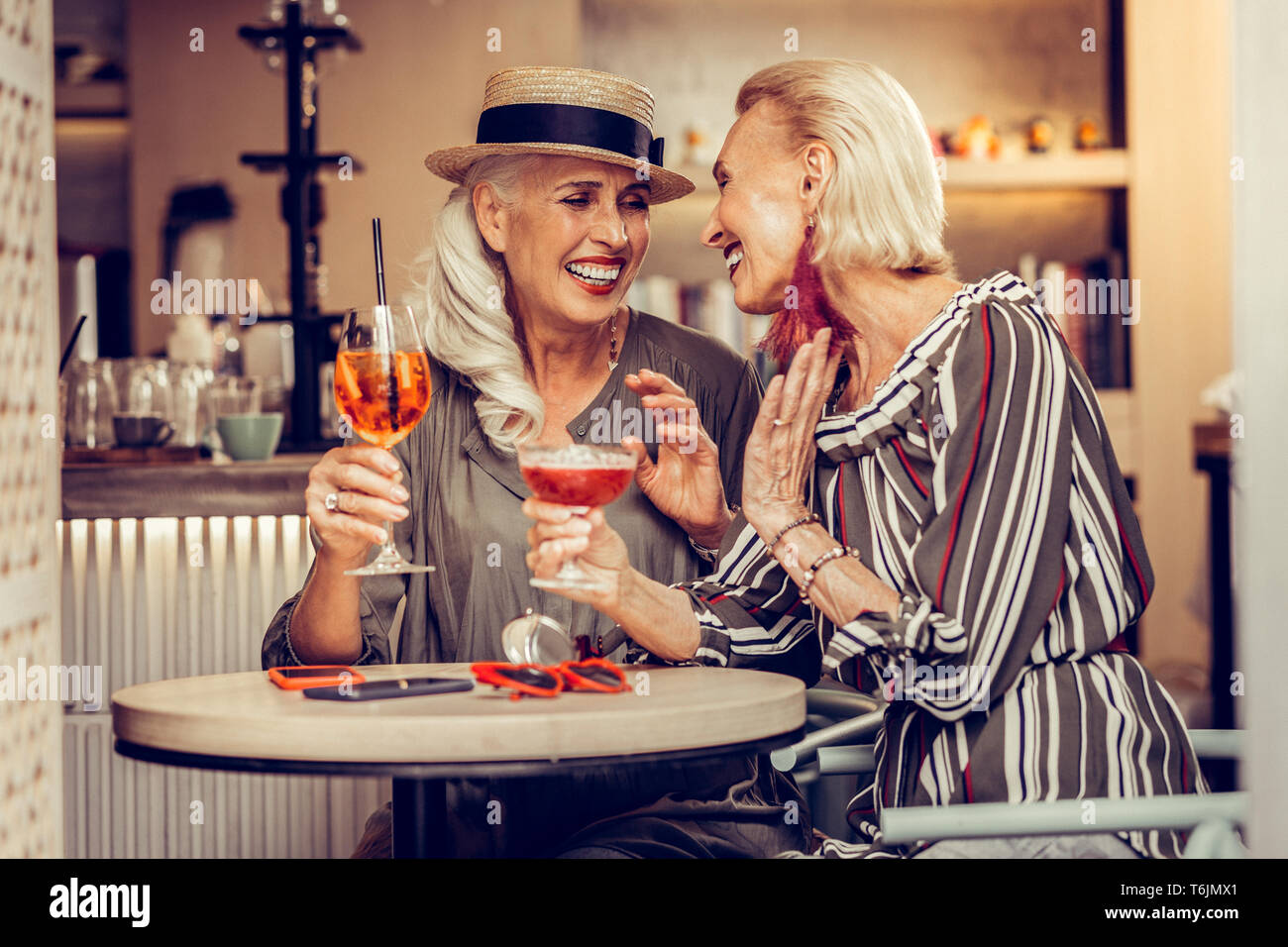 Laughing grey-haired ladies being excited with their meeting Stock Photo
