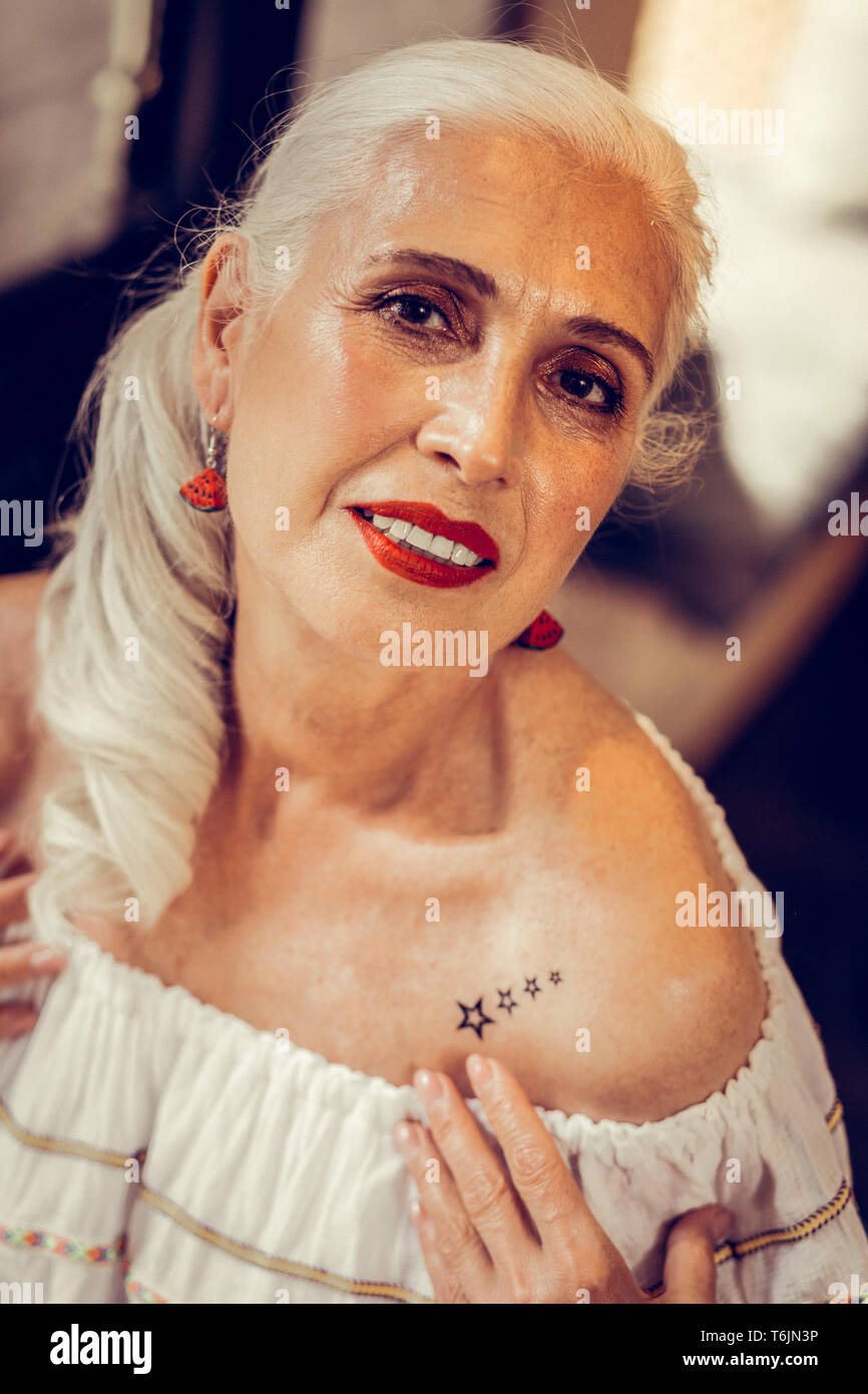Languid long-haired old woman having tied hair Stock Photo