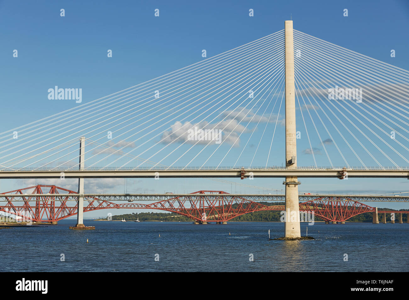 The new Queensferry Crossing bridge over the Firth of Forth with the older Forth Road bridge and the iconic Forth Rail Bridge in Edinburgh Scotland Stock Photo