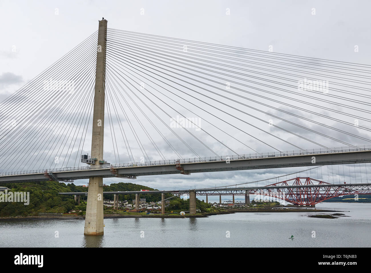 The new Queensferry Crossing bridge over the Firth of Forth with the older Forth Road bridge and the iconic Forth Rail Bridge in Edinburgh Scotland Stock Photo