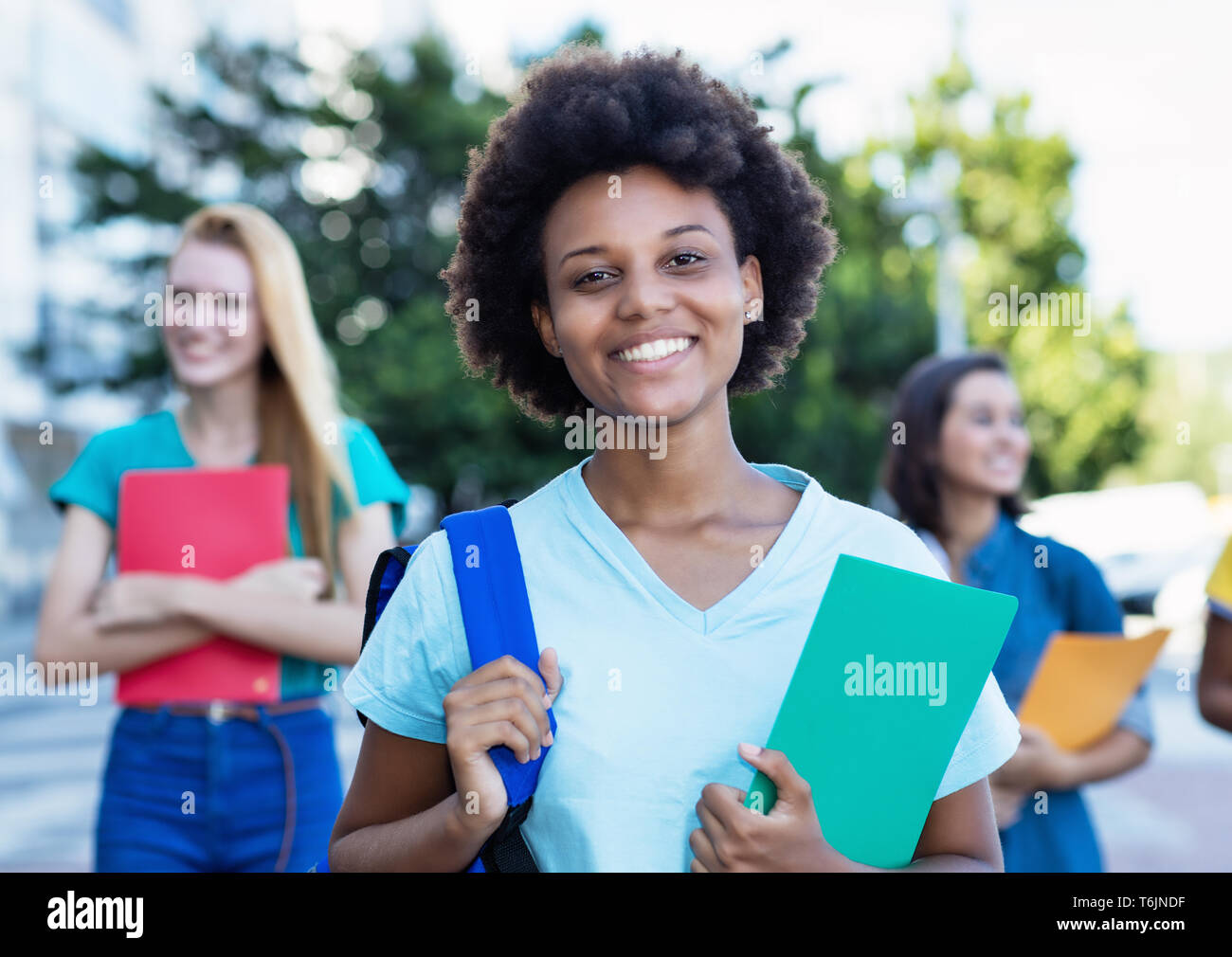 Young african american female student with group of women outdoor in the summer in the city Stock Photo
