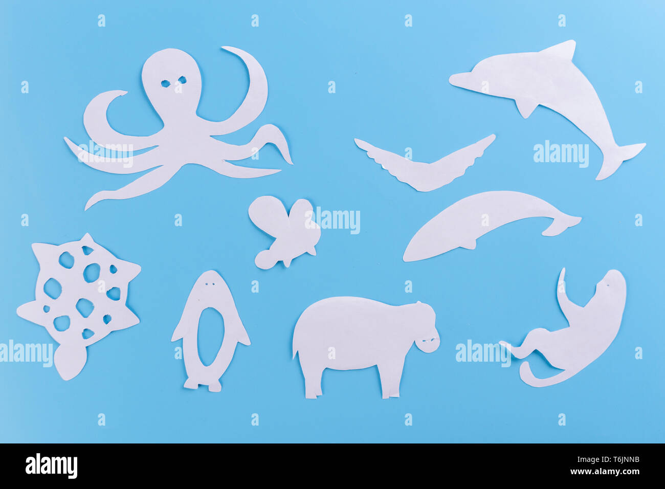 different animals made of paper. blue background Stock Photo