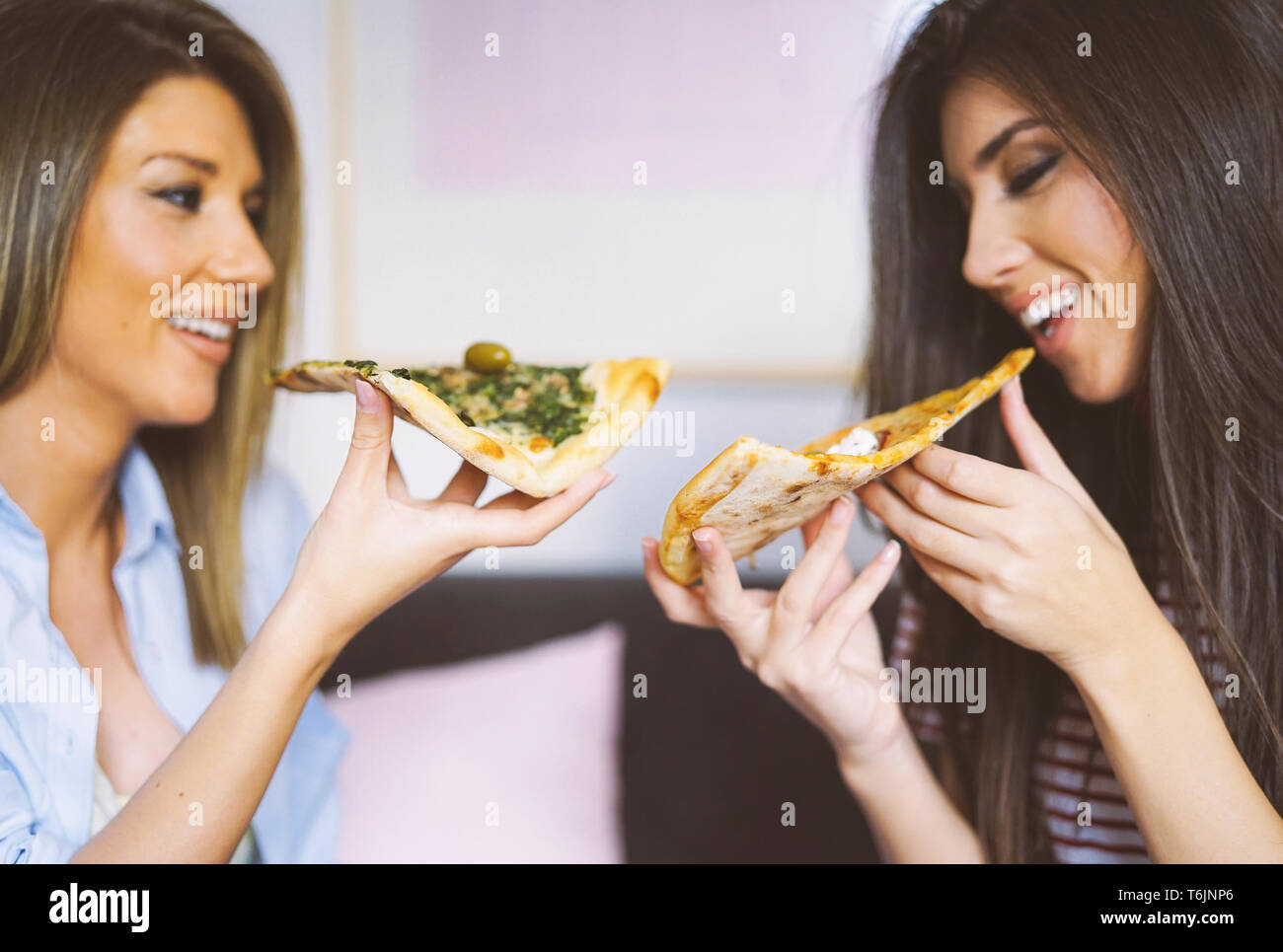 Group Of Friends Eating Pizza Together At Home Stock Photo, Picture and Royalty Free Image. Image 56950664.