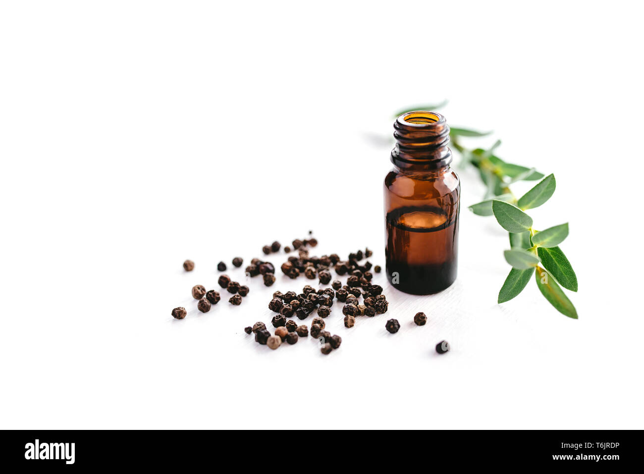 Black pepper essential oil isolated on white background for beauty