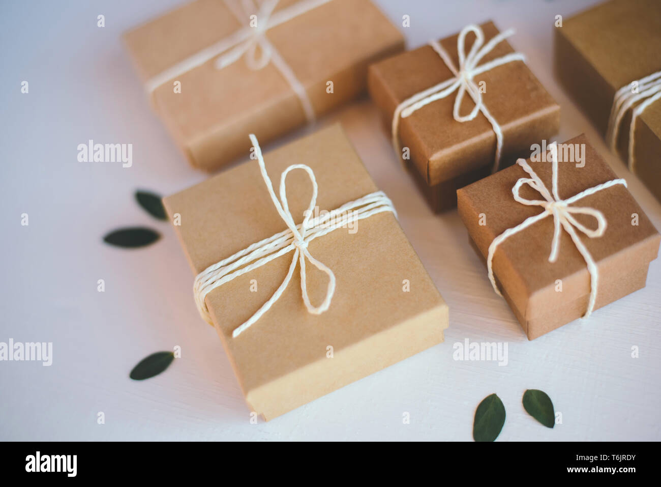 Craft gift boxes on white wooden background. Stock Photo