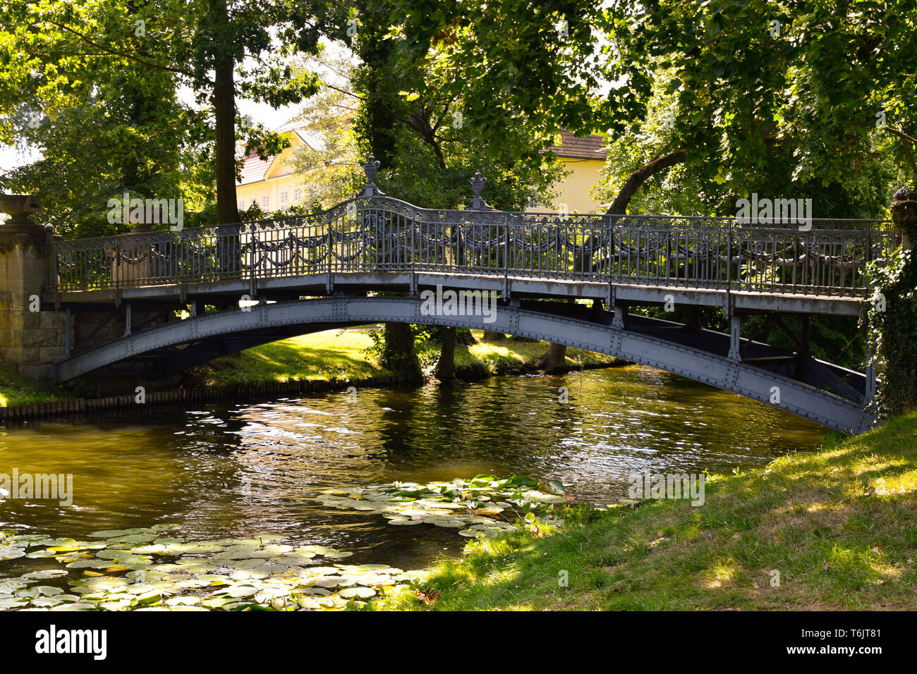 Steel bridge over a creek Stock Photo Alamy