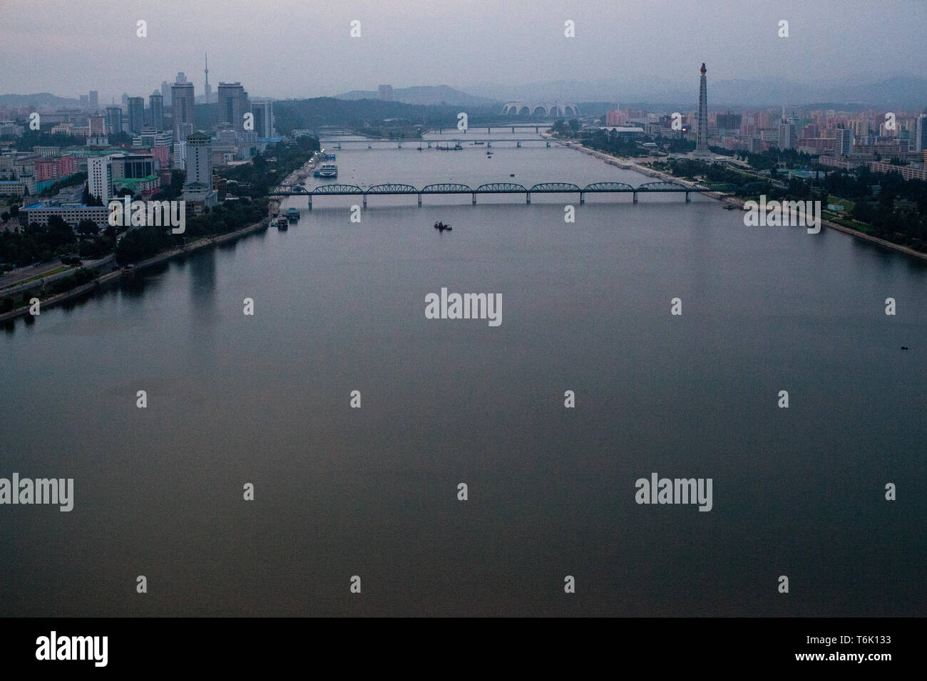 A view down the Taedong river in Pyongyang from the Yanggakdo Hotel. The Juche Idea Tower is on the right. Stock Photo