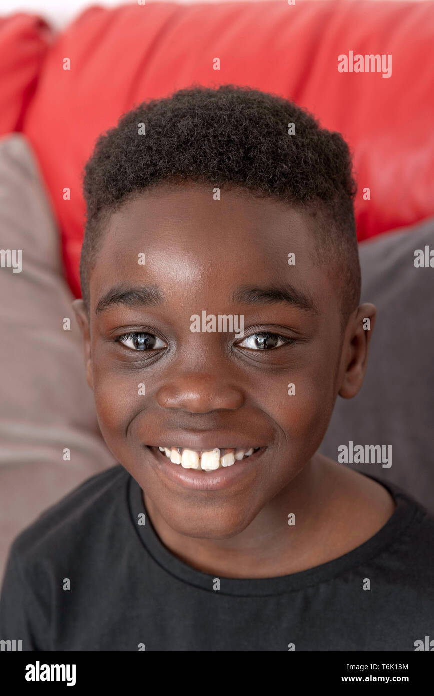 Portrait of a nine year old boy with a big smile, white teeth and curly hair  Stock Photo - Alamy