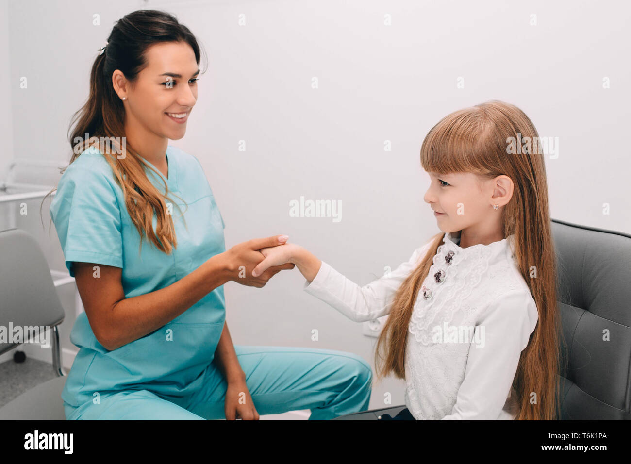 Handshake with little patient, at medical office. Consultation and reception of the children's doctor Stock Photo