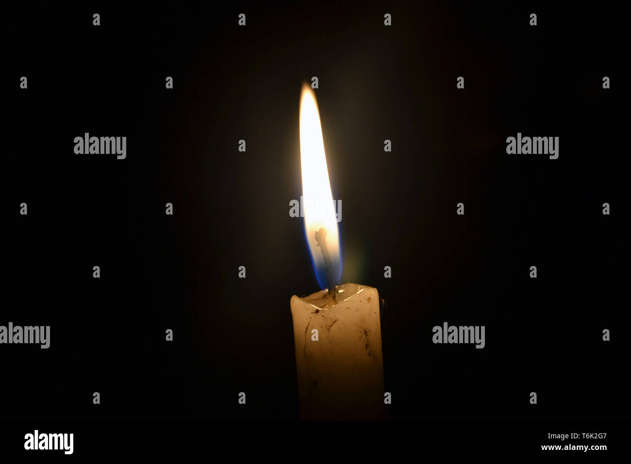 single candle burning in the dark Stock Photo Alamy