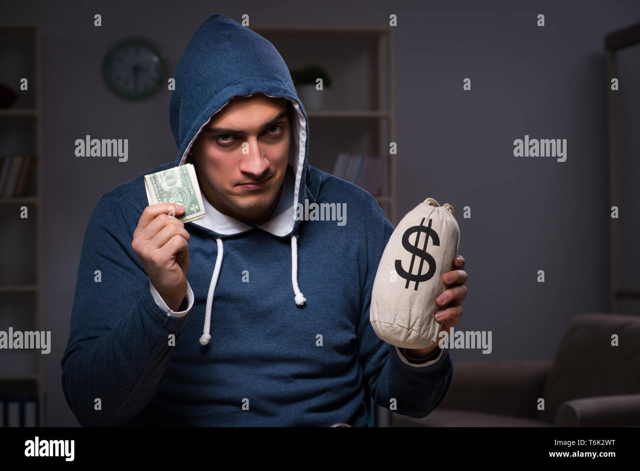 Hacker with sack of money Stock Photo - Alamy