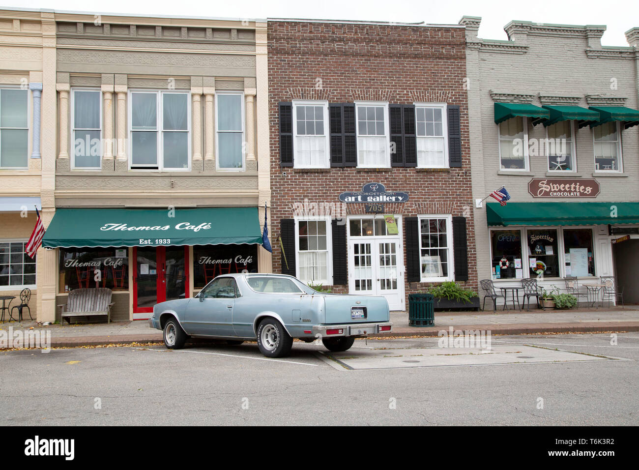 A Chevrolet pick-up truck is parked on a street in Georgetown in South Carolina, USA. It is next to a cafe and an art gallery. Stock Photo