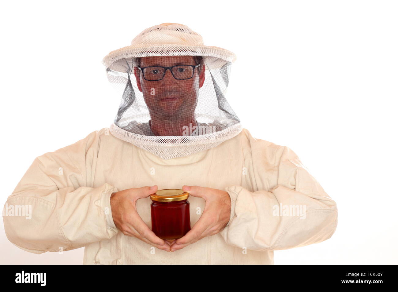 apiarist with honey glass in hands Stock Photo