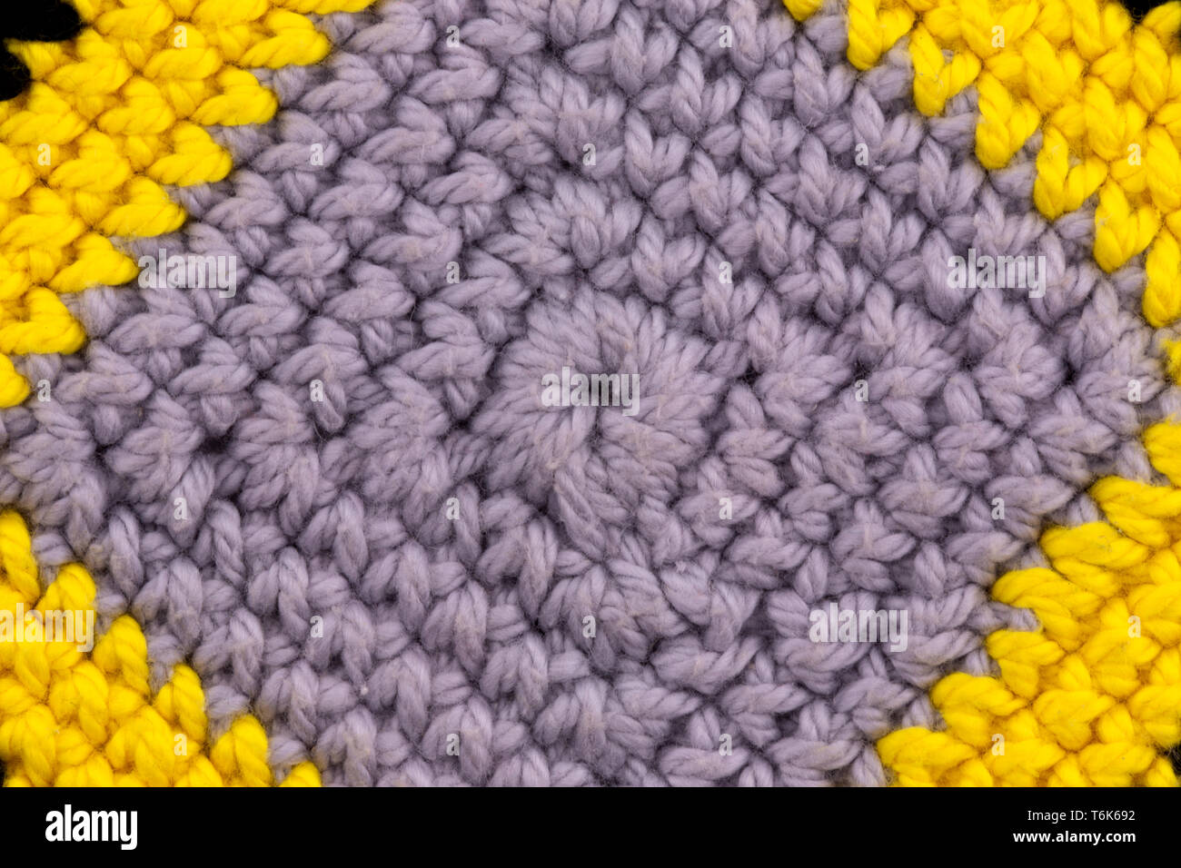 Abstract texture of a knitted fabric gray macro background with close-up. Stock Photo