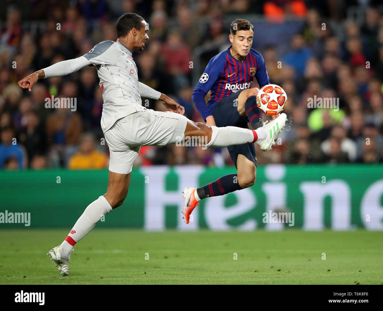 Liverpool's Joel Matip and Barcelona's Philippe Coutinho (right) battle for the ball during the UEFA Champions League semi final first leg match at the Nou Camp, Barcelona. Stock Photo