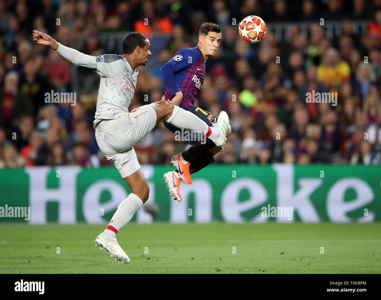 Liverpool's Joel Matip and Barcelona's Philippe Coutinho (right) battle for the ball during the UEFA Champions League semi final first leg match at the Nou Camp, Barcelona. Stock Photo