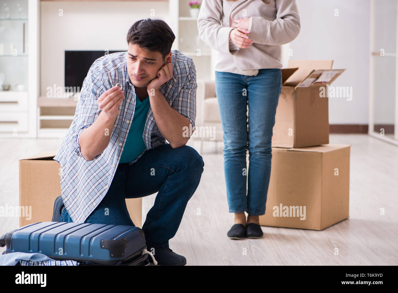 The woman evicting man from house during family conflict Stock Photo