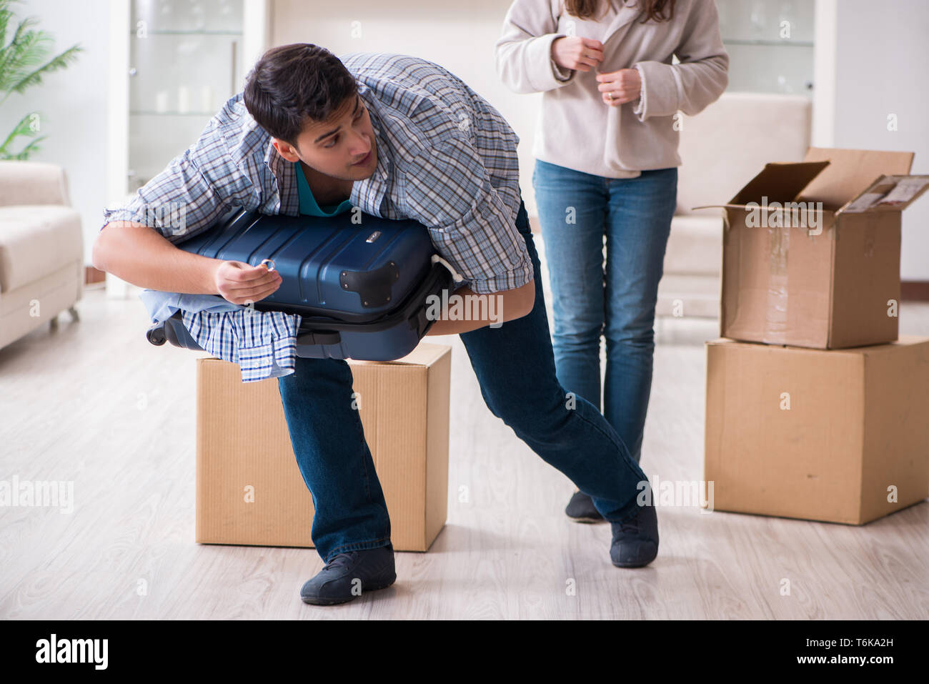 The woman evicting man from house during family conflict Stock Photo