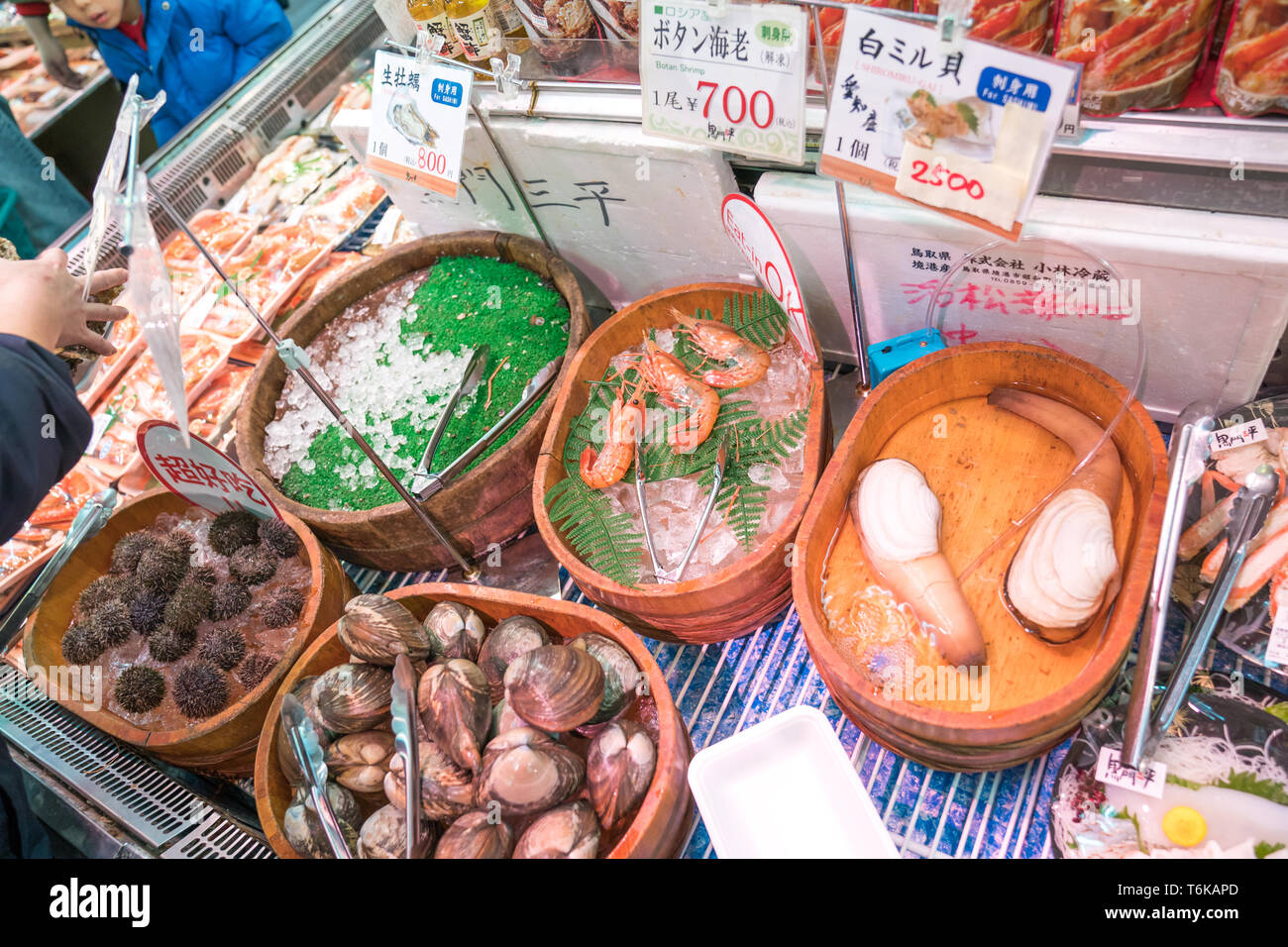 Osaka, Japan - 3 Mar 2018; Fresh shellfish ready to cook in the restaurant at fish market, Japan. Stock Photo