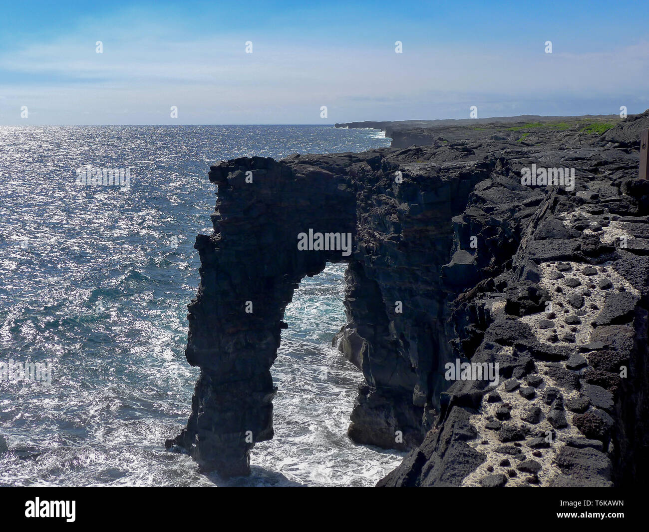 Horizontal view on Holei sea arch at Big Island, Hawaii. A natural from lava stone originated arch. Stock Photo