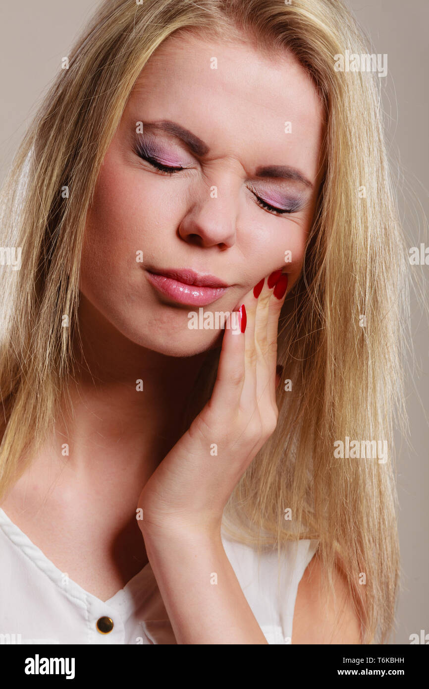 Dental care and toothache. Closeup young woman face worried girl