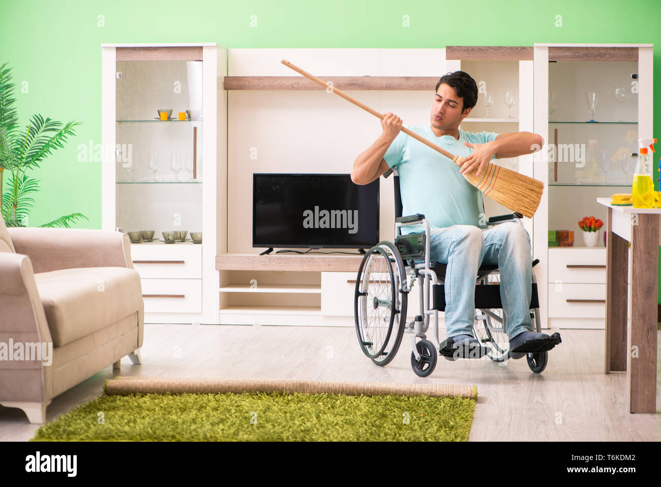 Disabled man on wheelchair cleaning house Stock Photo Alamy