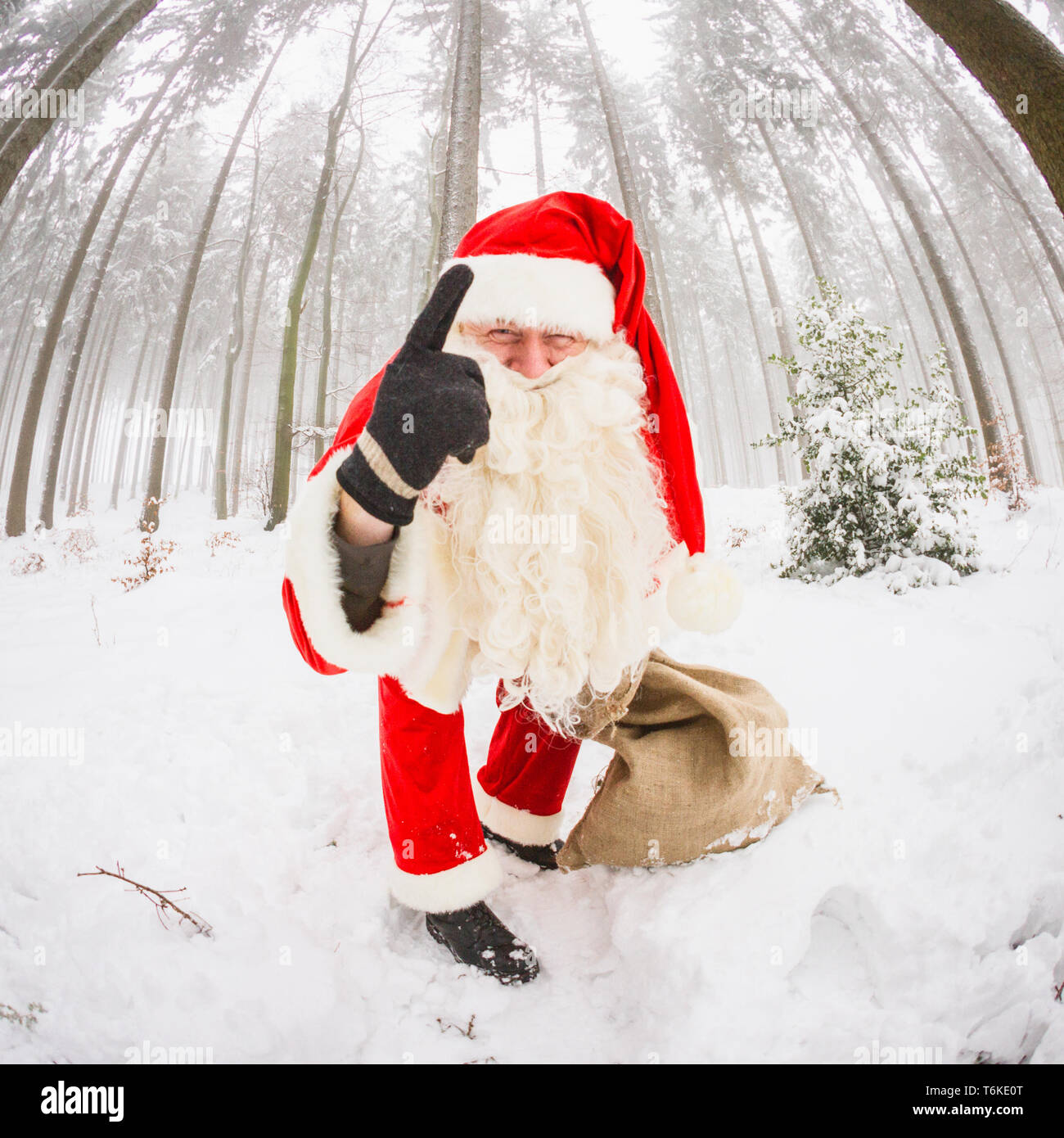 Santa Claus pointing with his index fingers up Stock Photo