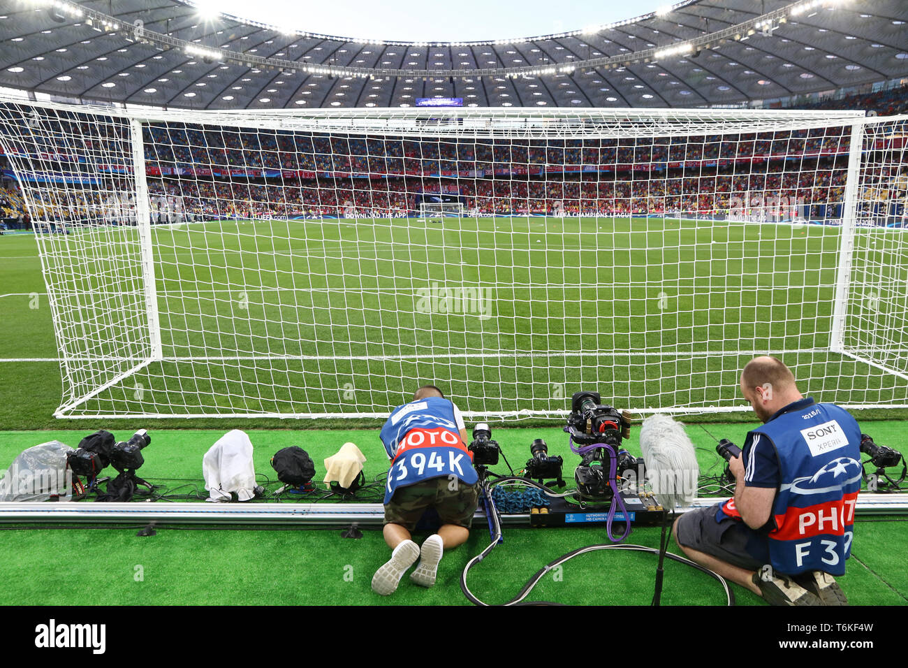 Sport photographers install the remote cameras behind the goal net before the UEFA Champions League Final 2018 game Real Madrid v Liverpool Stock Photo