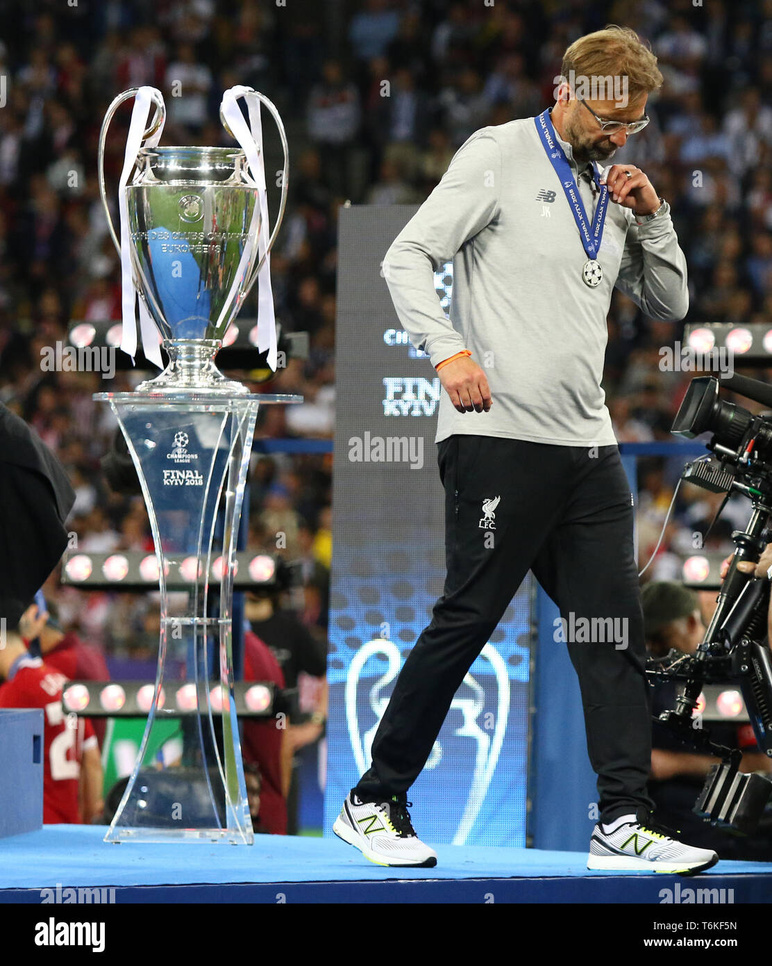 Liverpool manager Jurgen Klopp goes past the pedestal with Champions League Trophy (Cup) at Medal Ceremony after the UEFA Champions League Final 2018 Stock Photo