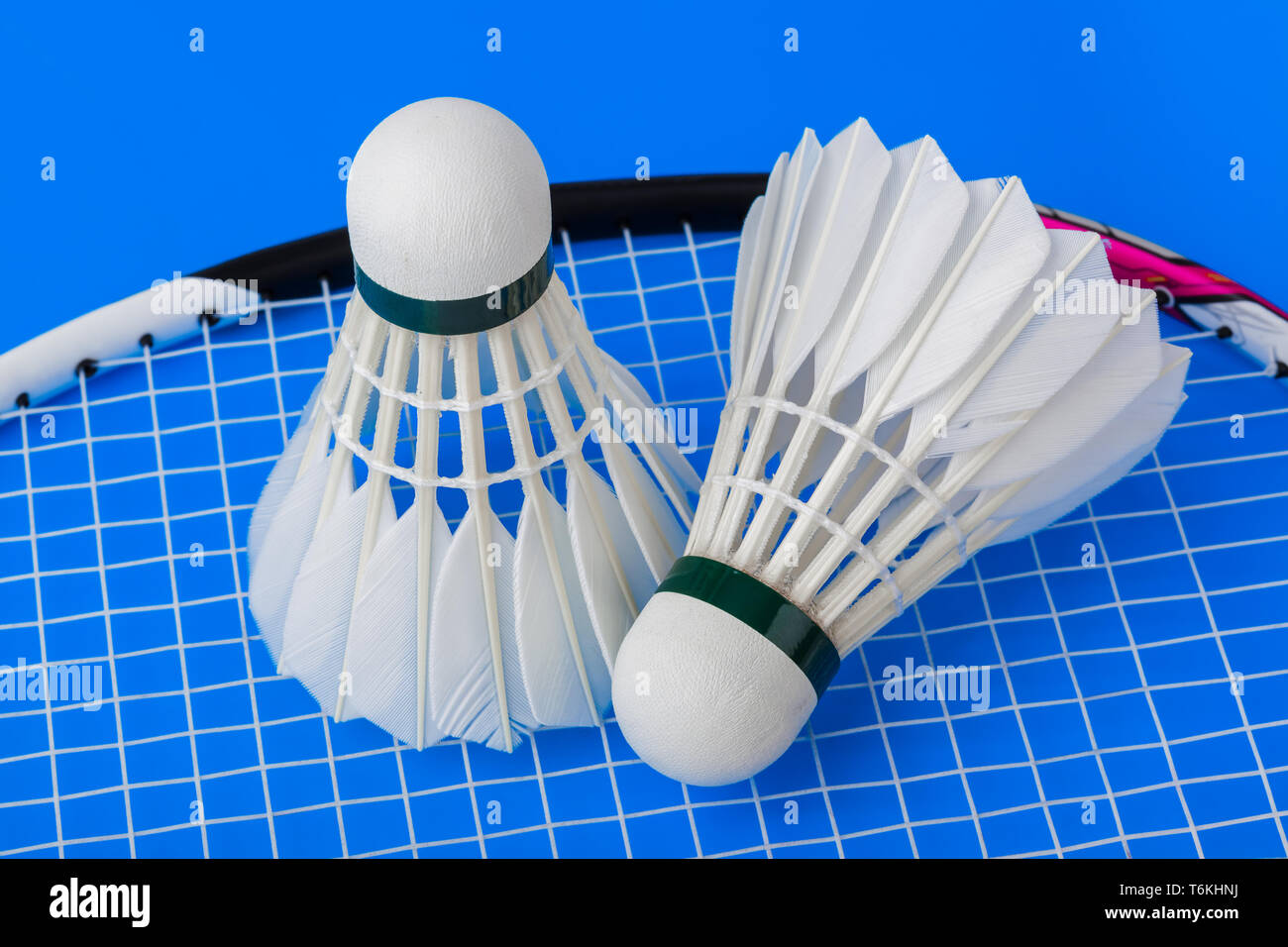 Badminton shuttlecocks and racket on blue background Stock Photo