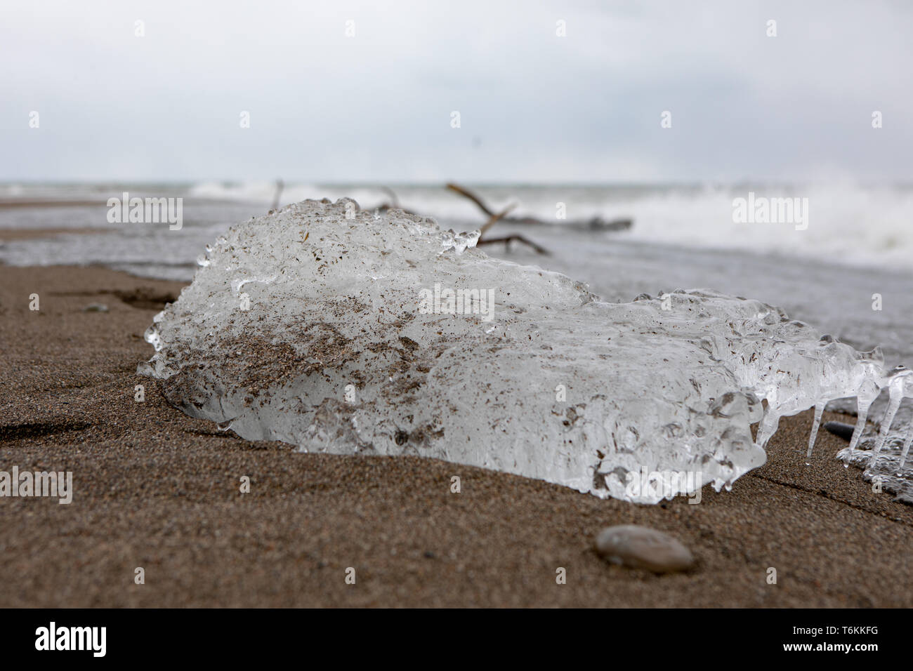 Abstract Outdoor Elements Frozen Ice Block Sandy Beach Trail Waves Background Stock Photo
