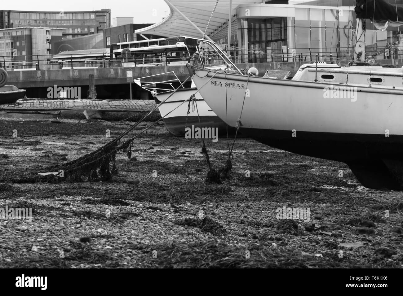 Sailing boat in the Portsmouth harbour with low tide. Portsmouth