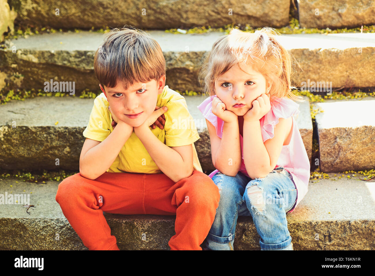 small girl and boy on stairs. Relations. summer vacation ...