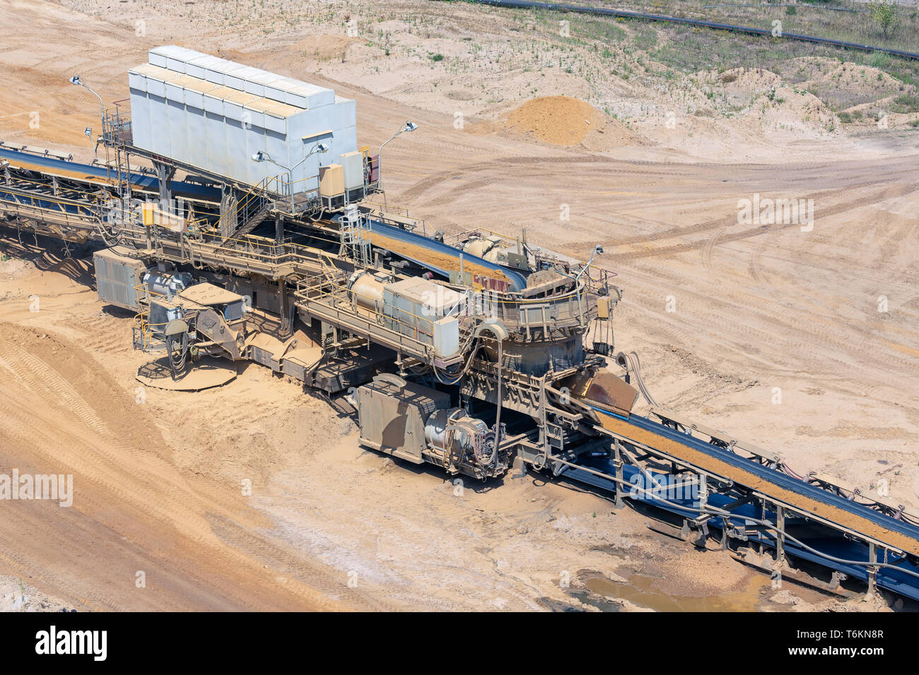 Brown coal open pit landscape with conveyor belt in Germany Stock Photo