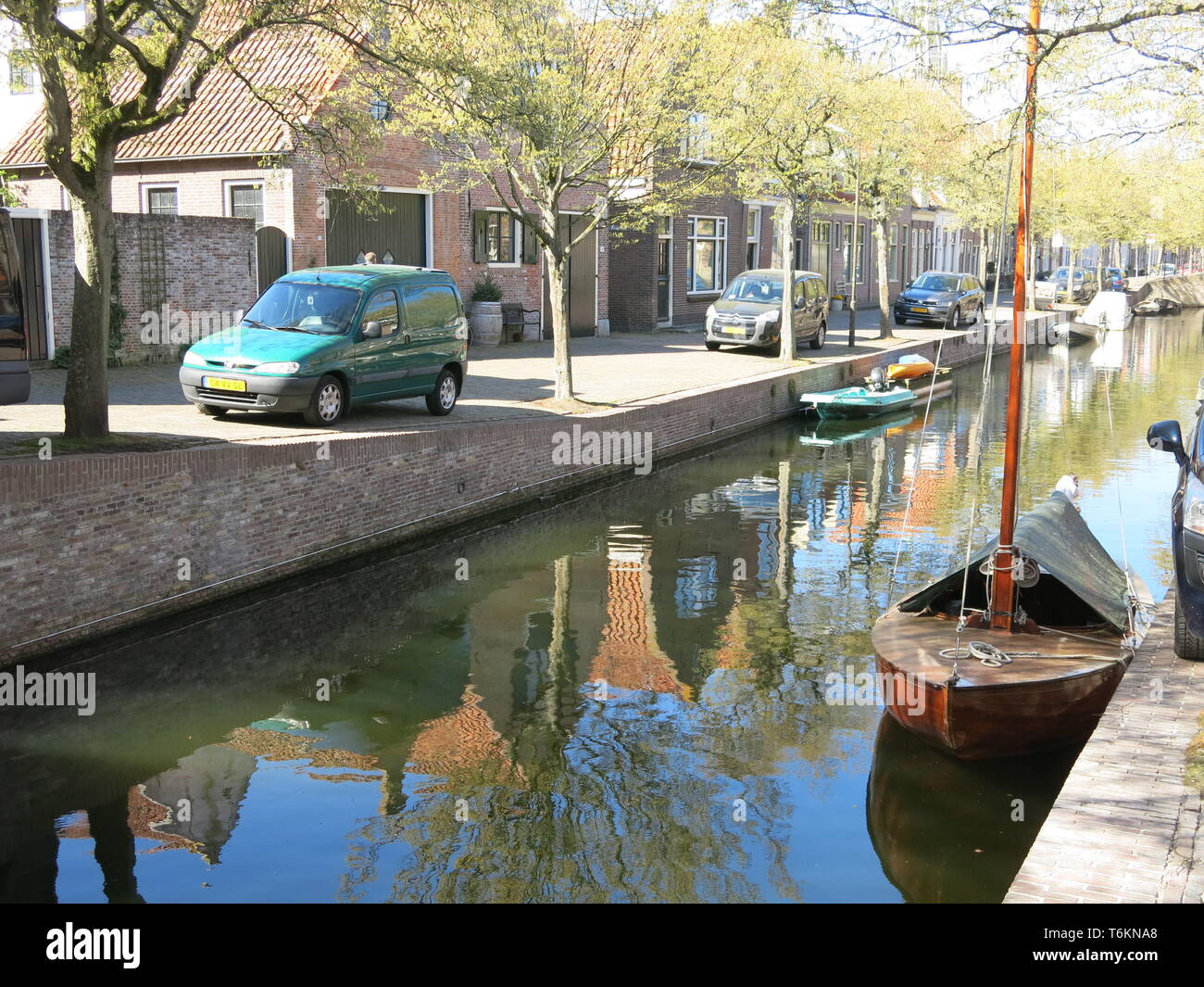 View of one of the canals that runs through the pretty town of Enhuizen, a popular tourist destination in North Holland; April 2019 Stock Photo