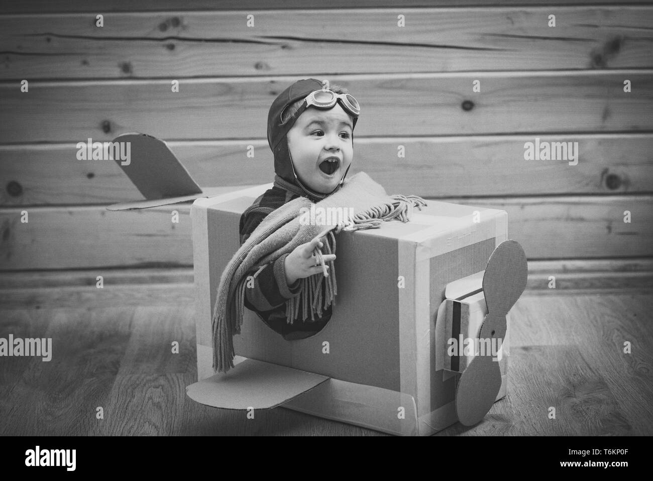child in a cardboard box playing Stock Photo