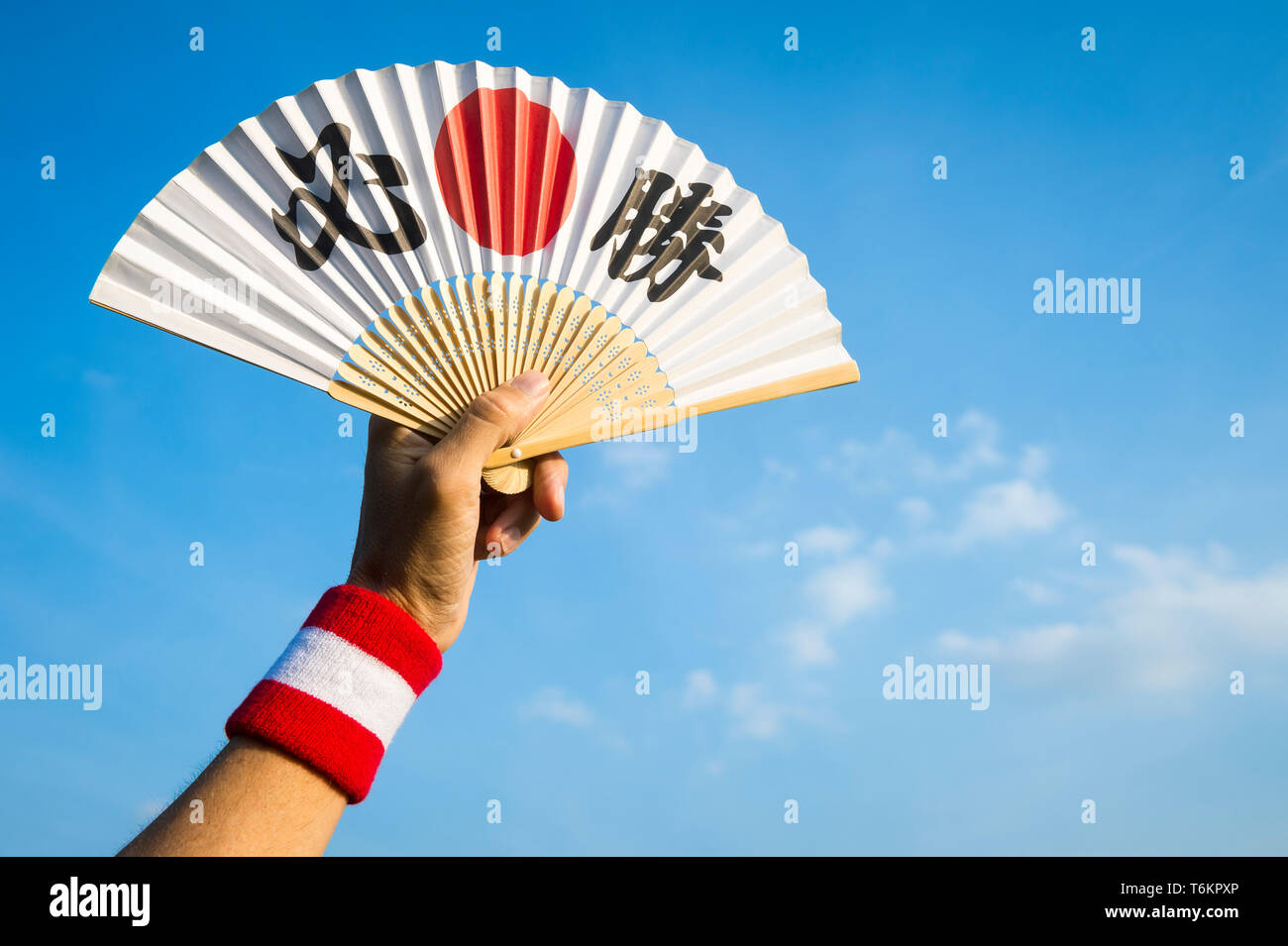 Hand Of Sports Supporter With Japan Flag Colors Wristband Holding Fan Decorated With Kanji Characters Spelling Out Hisshō Certain Victory In English Stock Photo Alamy Hand Of Sports Supporter With Japan Flag Colors Wristband Holding Fan Decorated With Kanji Characters Spelling Out Hisshō Certain Victory In English Stock Photo Alamy