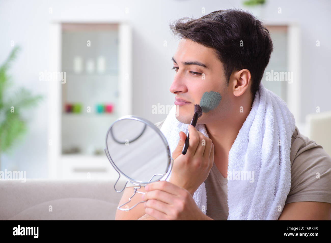 Handsome applying clay mask on face Stock Photo Alamy