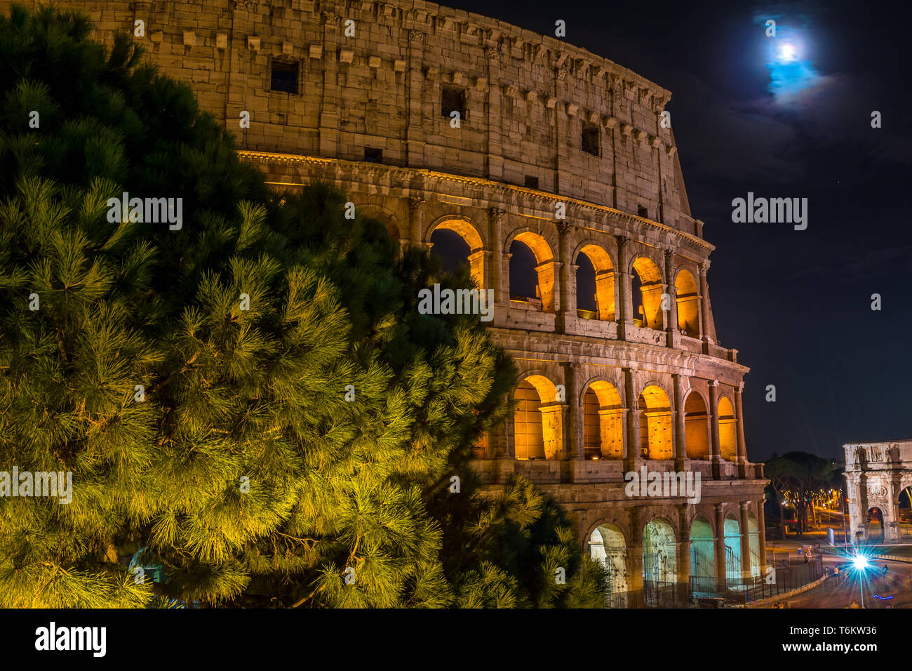 Coliseum with the new moon and the Arch of Constantine in Rome - Italy Stock Photo