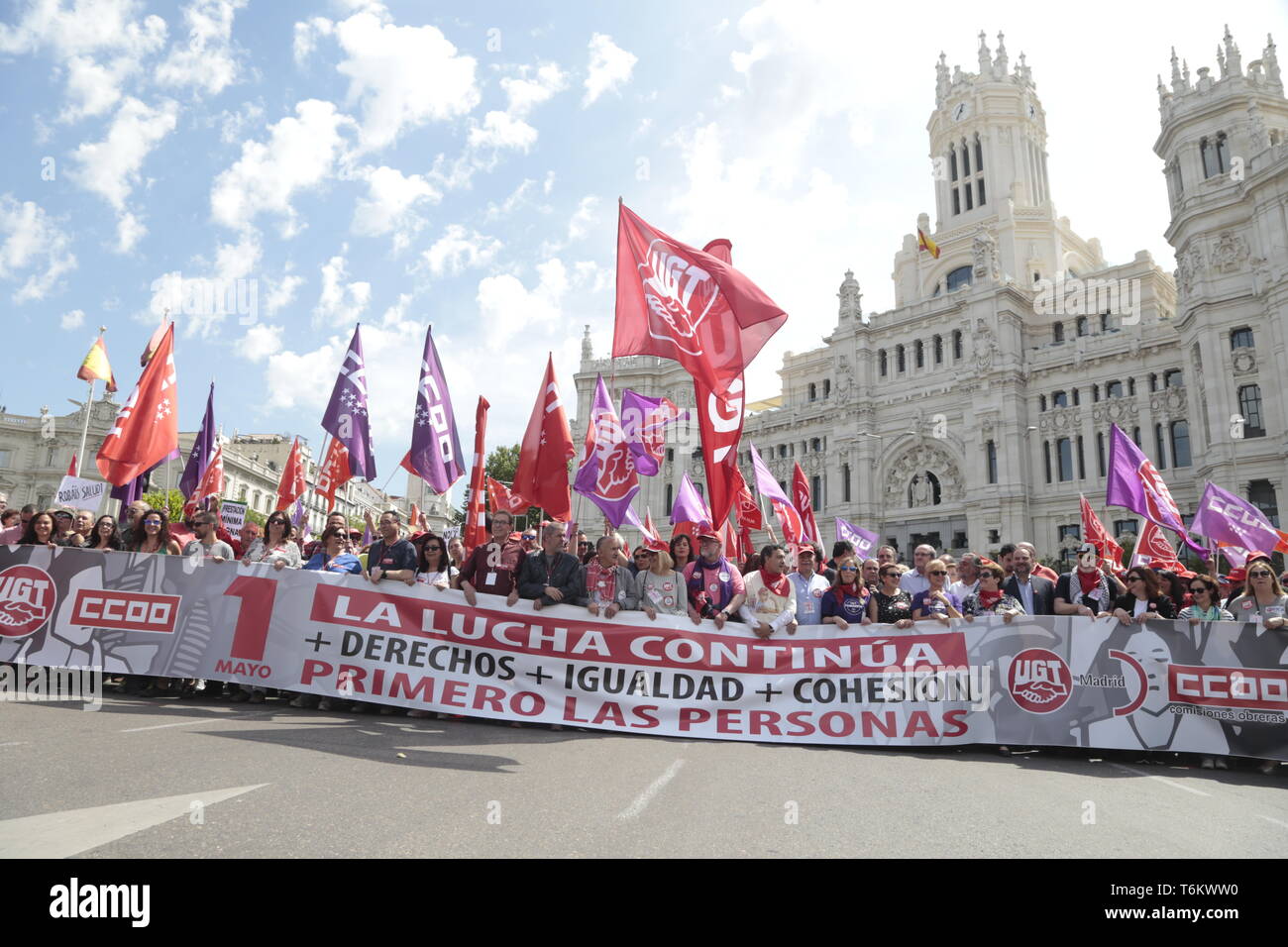 Protesters are seen holding a banner and flags during the demonstration. Thousands of protesters demonstrate on the International Workers' Day convoked by the majority unions UGT and CCOO to demand policies and reductions in unemployment levels in Spain, against job insecurity and labour rights. Politicians of the PSOE and Podemos have participated in the demonstration. Stock Photo