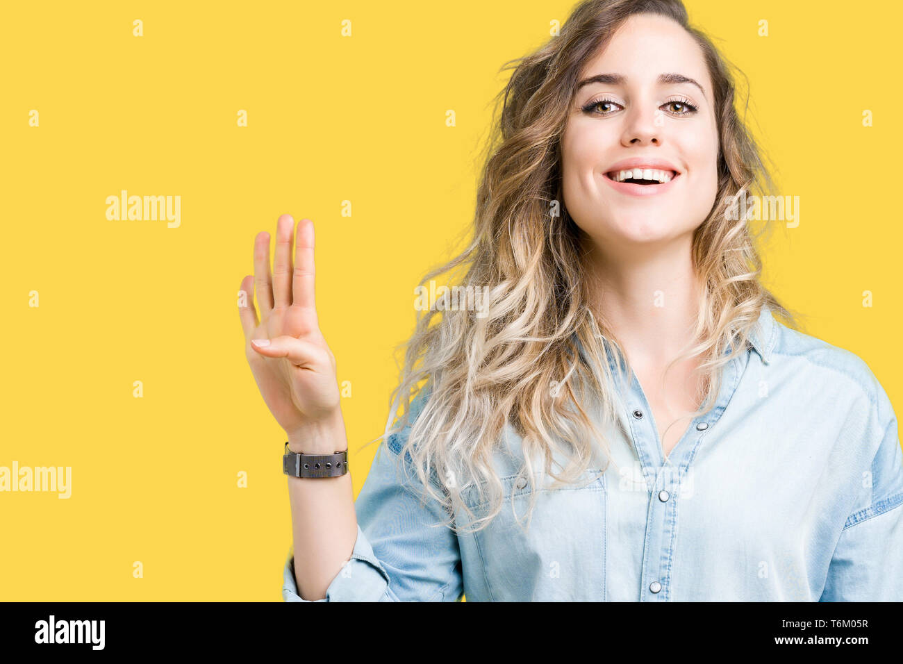 beautiful-young-blonde-woman-over-isolated-background-showing-and