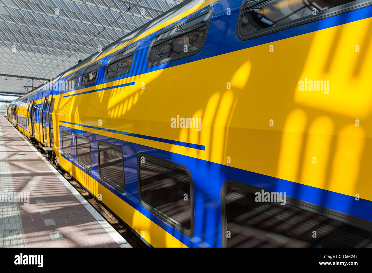 Big yellow train at a Dutch railway station Stock Photo